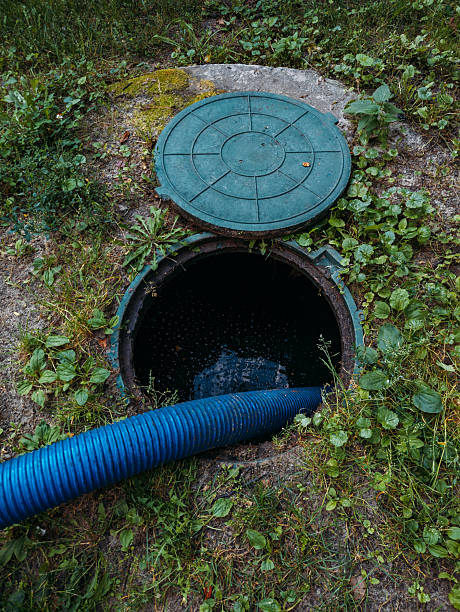 process of cleaning up sewage collector. pumping out household septic tank.